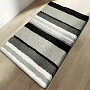 striped bath rug with grey, black and white stripes